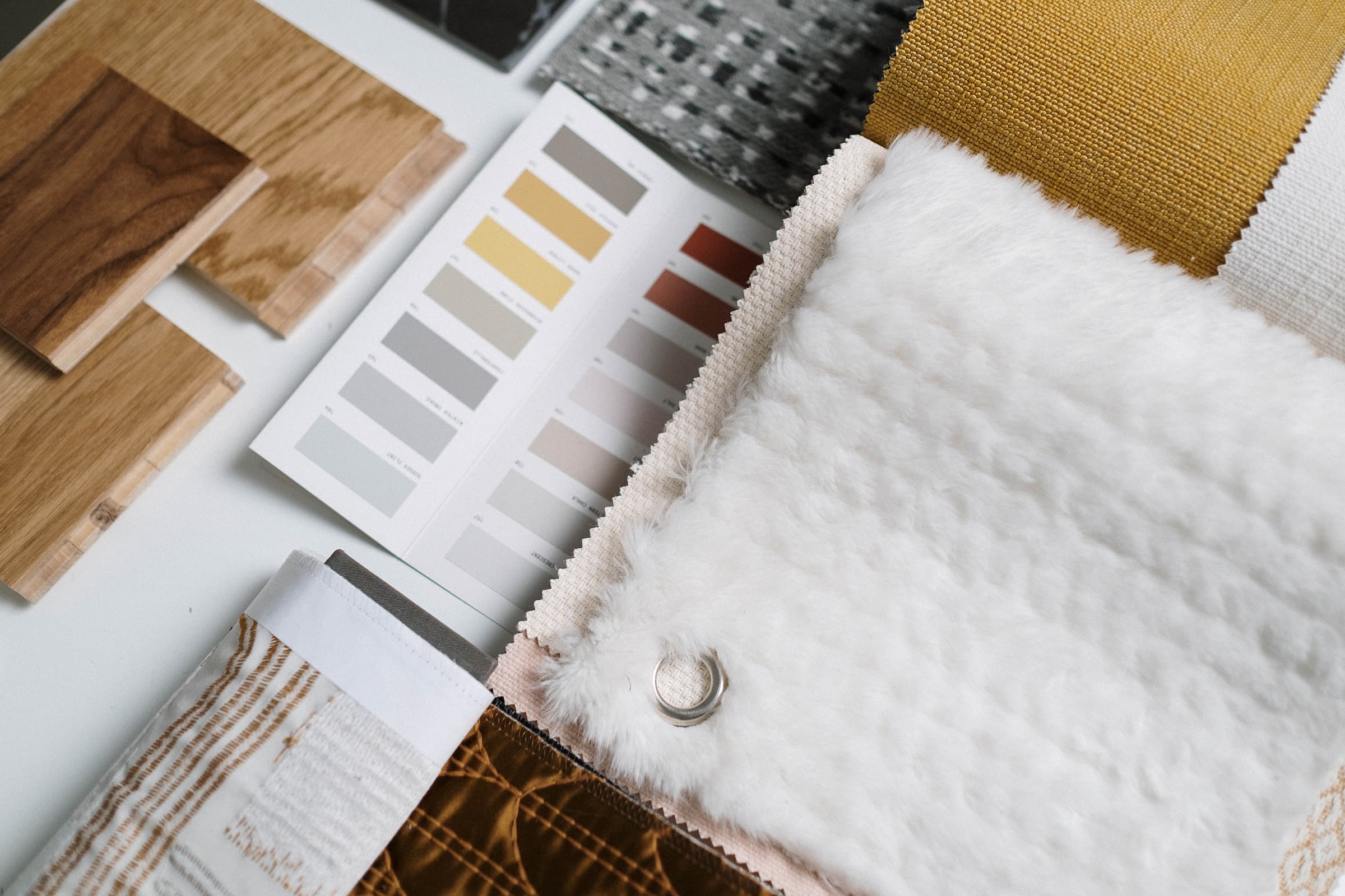 Several samples of home decor materials on a table