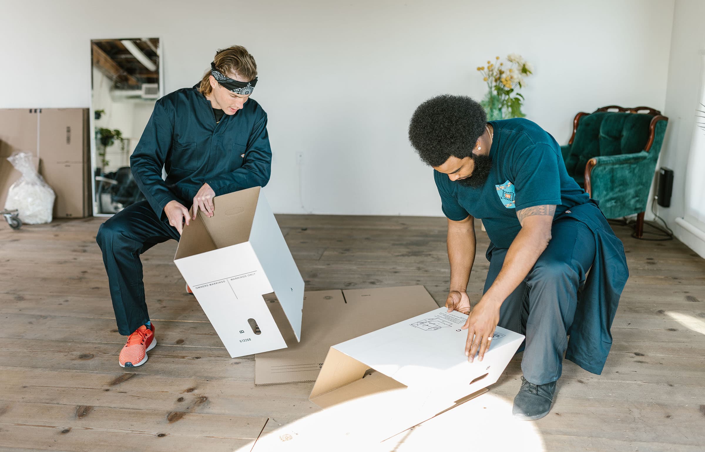 Movers assemble moving boxes