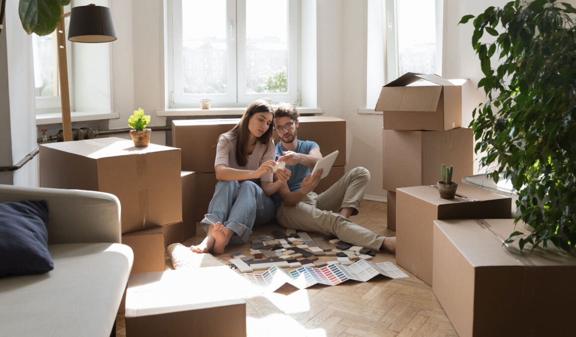 Young married couple of new homeowners selecting finishing interior materials