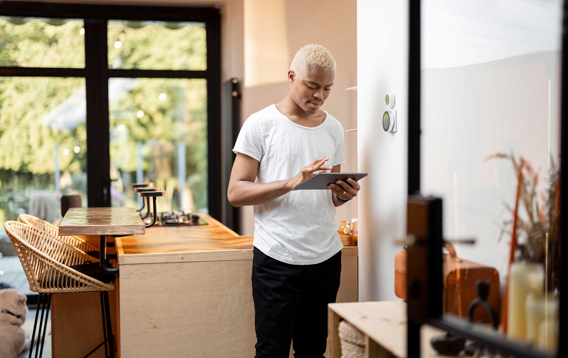 Latin man choosing temperature on thermostat