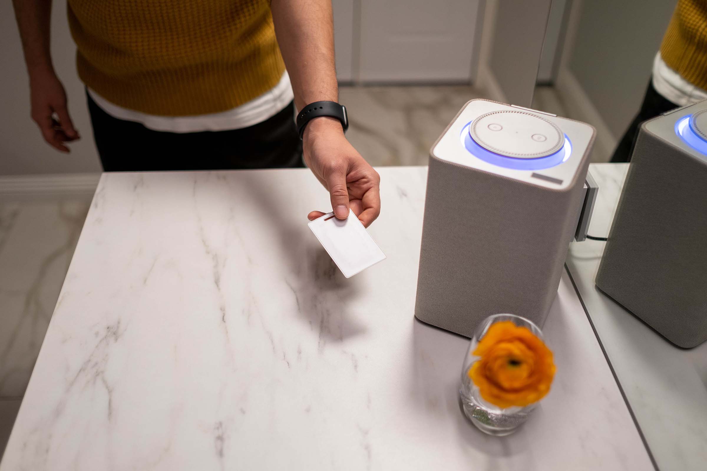 Person standing near smart speaker