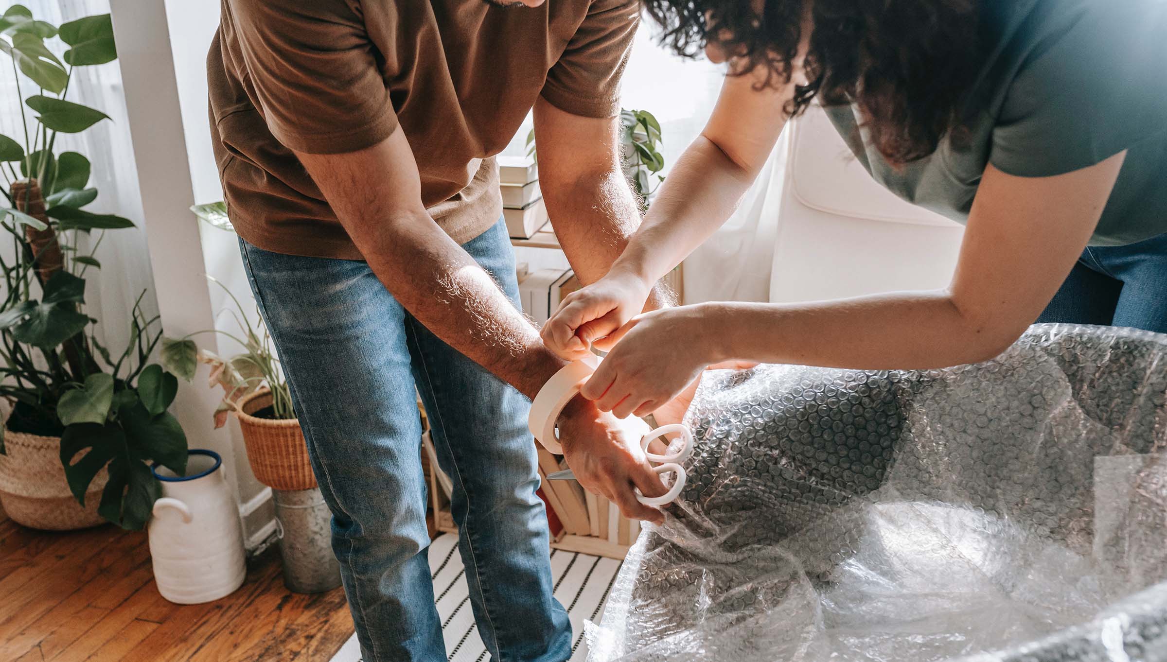 Couple wraps a chair in bubble wrap